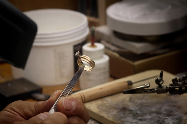 Jeweler working on a ring at the workbench
